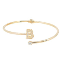 Gold-tone open bangle bracelet with dangling crystal charms and initial B