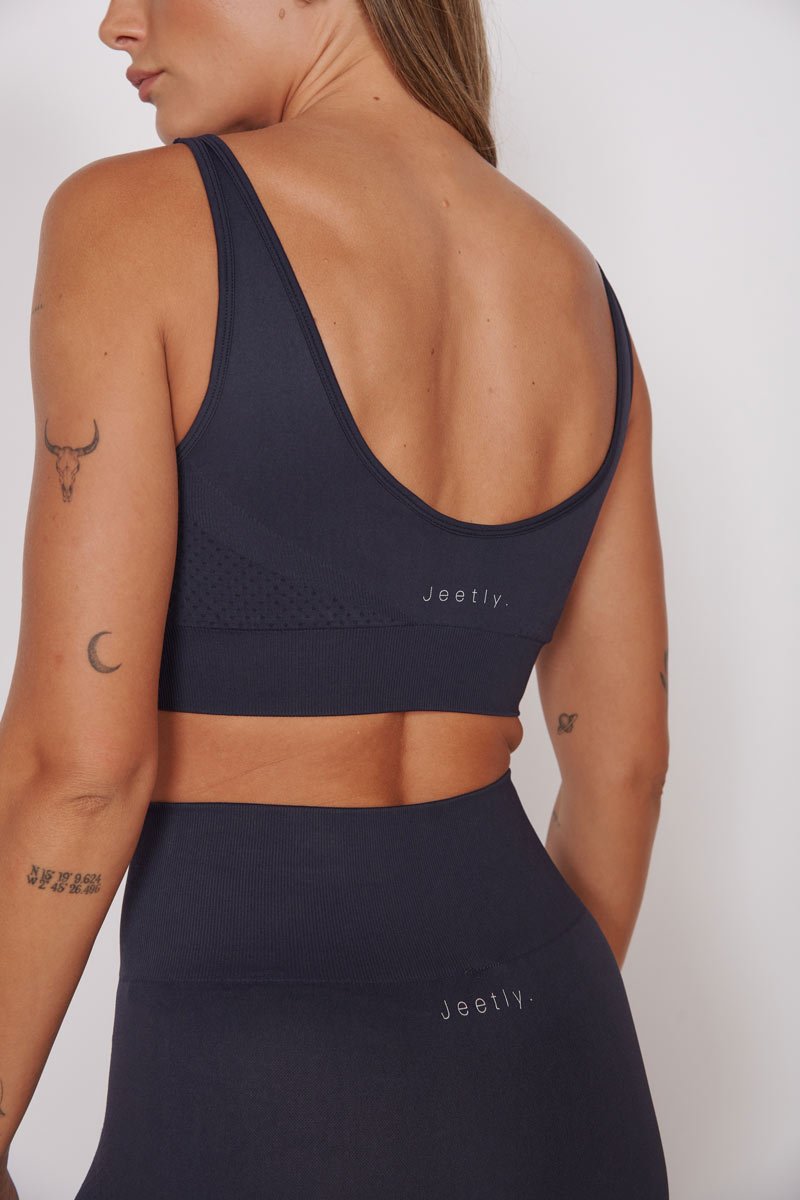 Petite seam-free sports bra in navy with racerback and open back, sleeveless