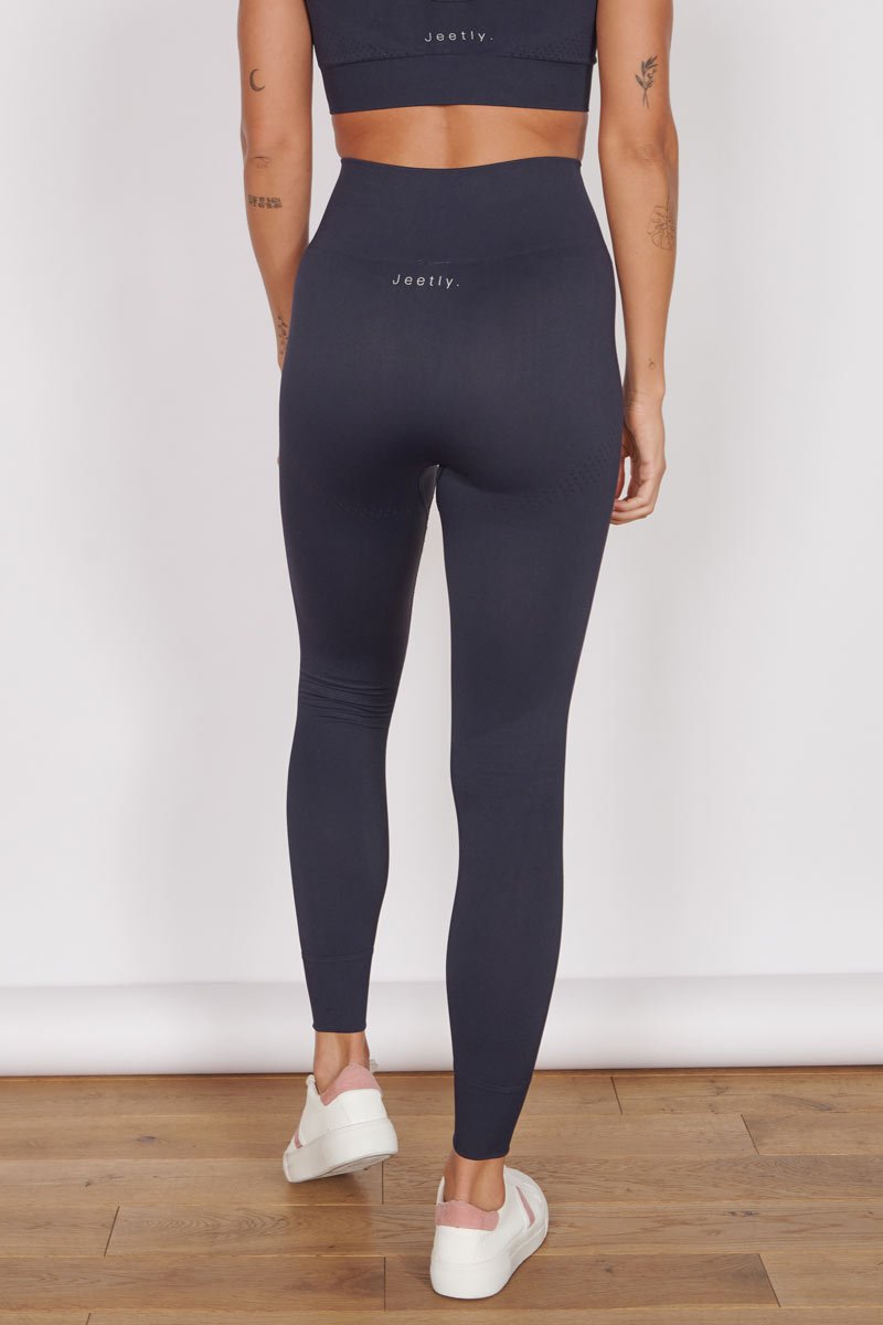 High-waist navy seamless leggings, full-length with a streamlined, smooth look.