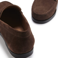 Brown suede loafer close-up showing the heel and stitched toe details