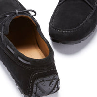 Pair of black suede driving loafers showing laces and textured heel grips
