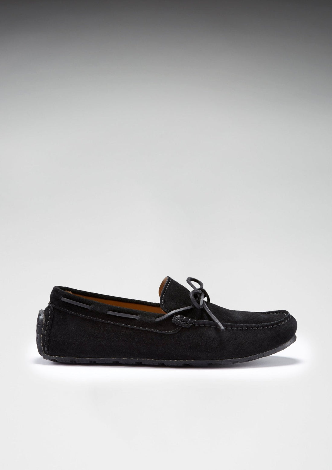 Side view of black suede laced driving loafer with a low-profile sole