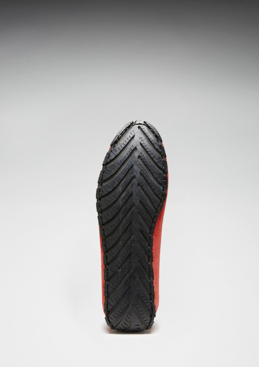Driving loafer with a black rubber outsole and chevron tread