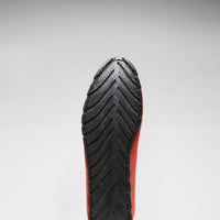Driving loafer with a black rubber outsole and chevron tread