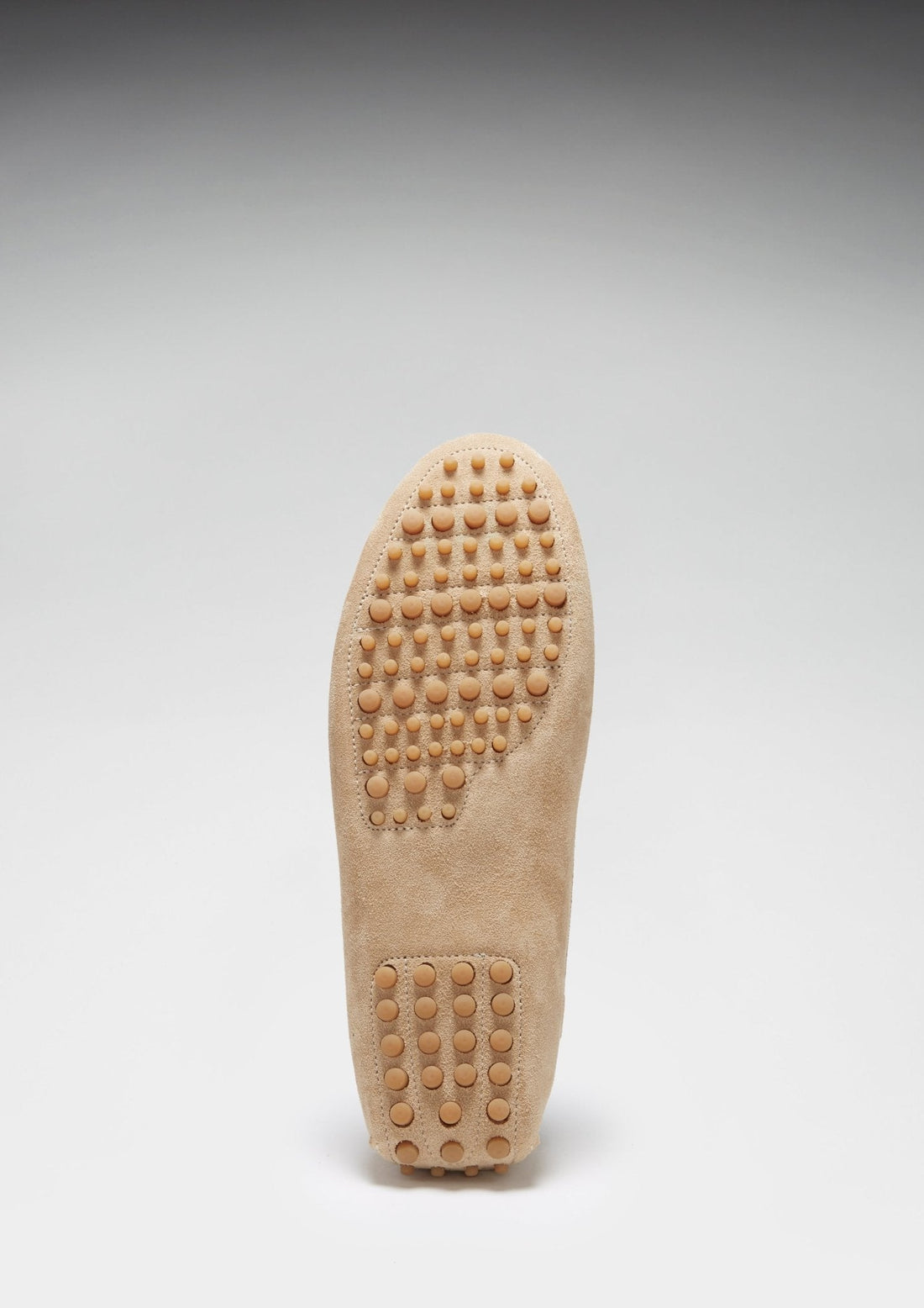 Driving loafer sole with rounded rubber traction pegs at the toe and heel