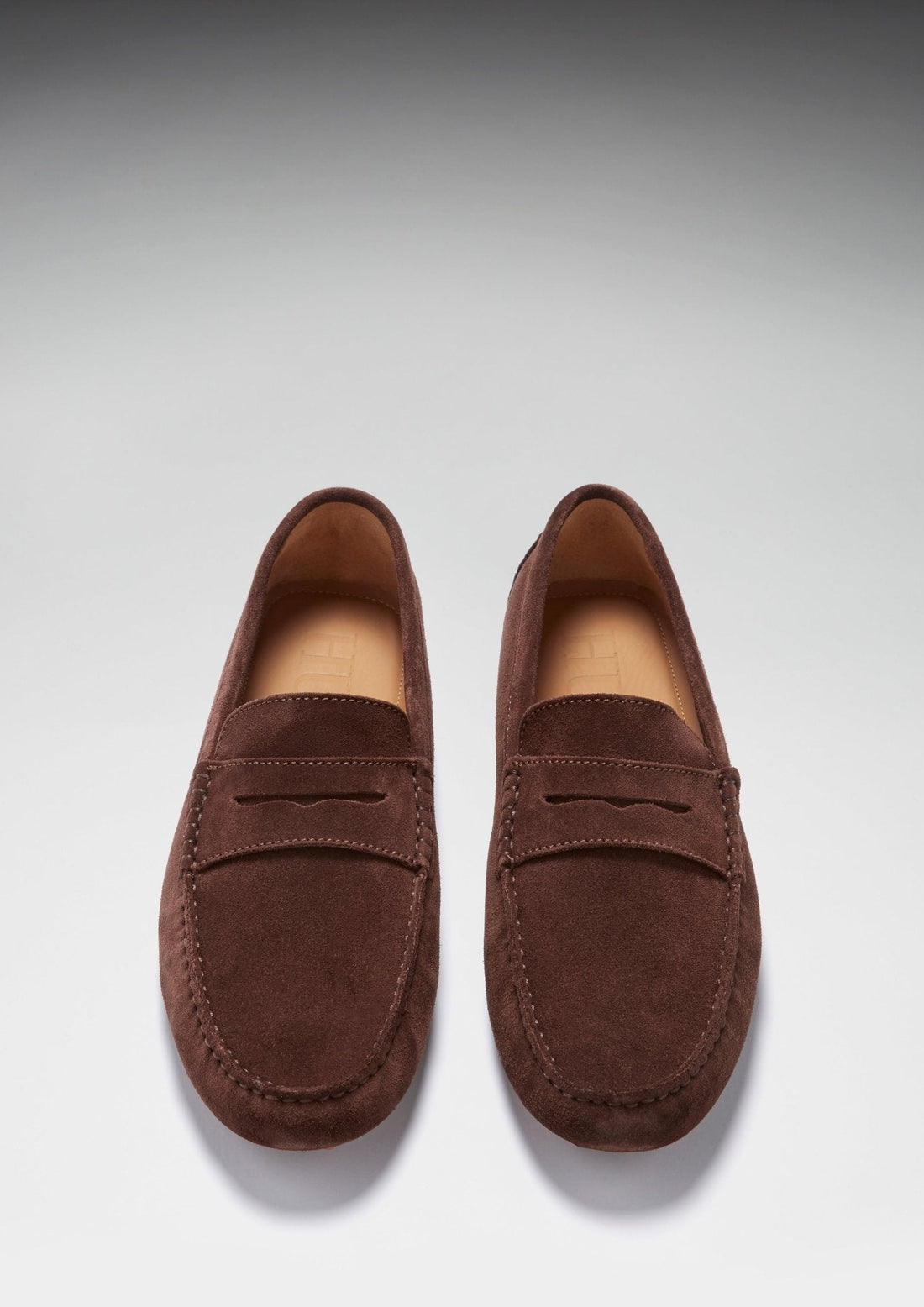 Pair of brown suede penny driving loafers, viewed from above