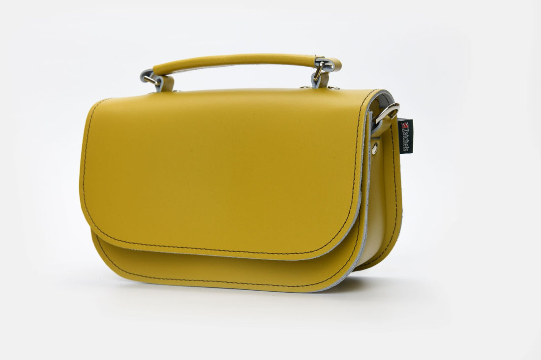 Yellow ochre leather mini bag with adjustable strap and flap front