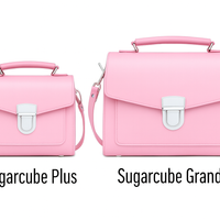 Two pastel pink leather flap handbags side by side, each with metal buckle clasp.