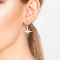 Silver starburst drop earrings with sparkly star charms and dangling detail