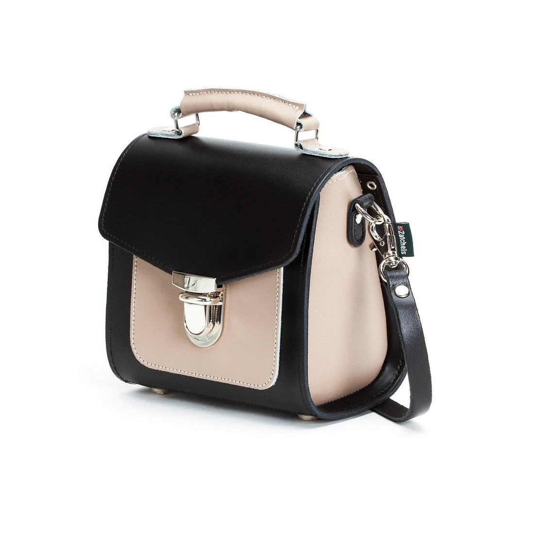 Black leather crossbody handbag with beige panel and silver top buckle, side view
