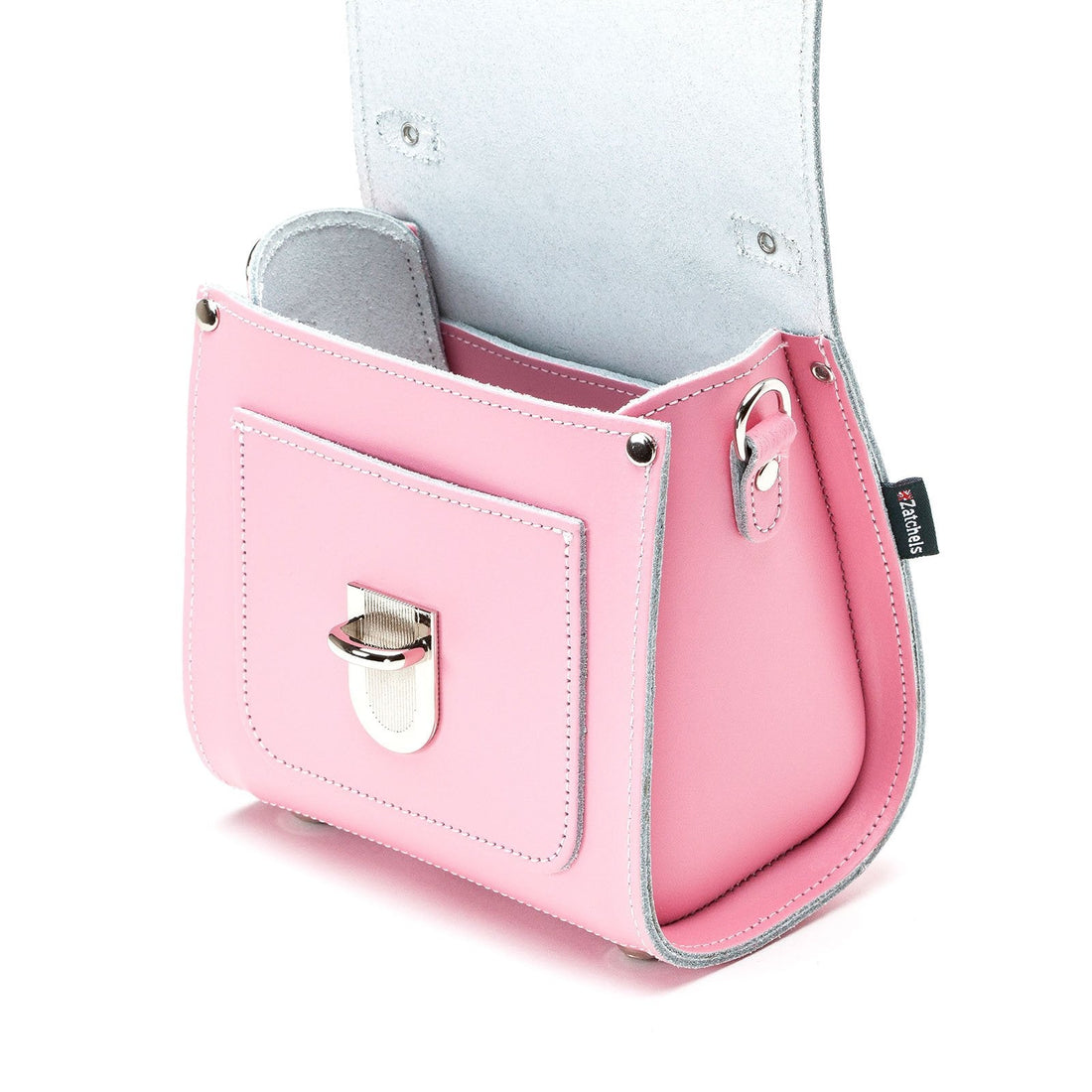 Pastel pink leather handbag interior lining with side pocket and metal clasp.