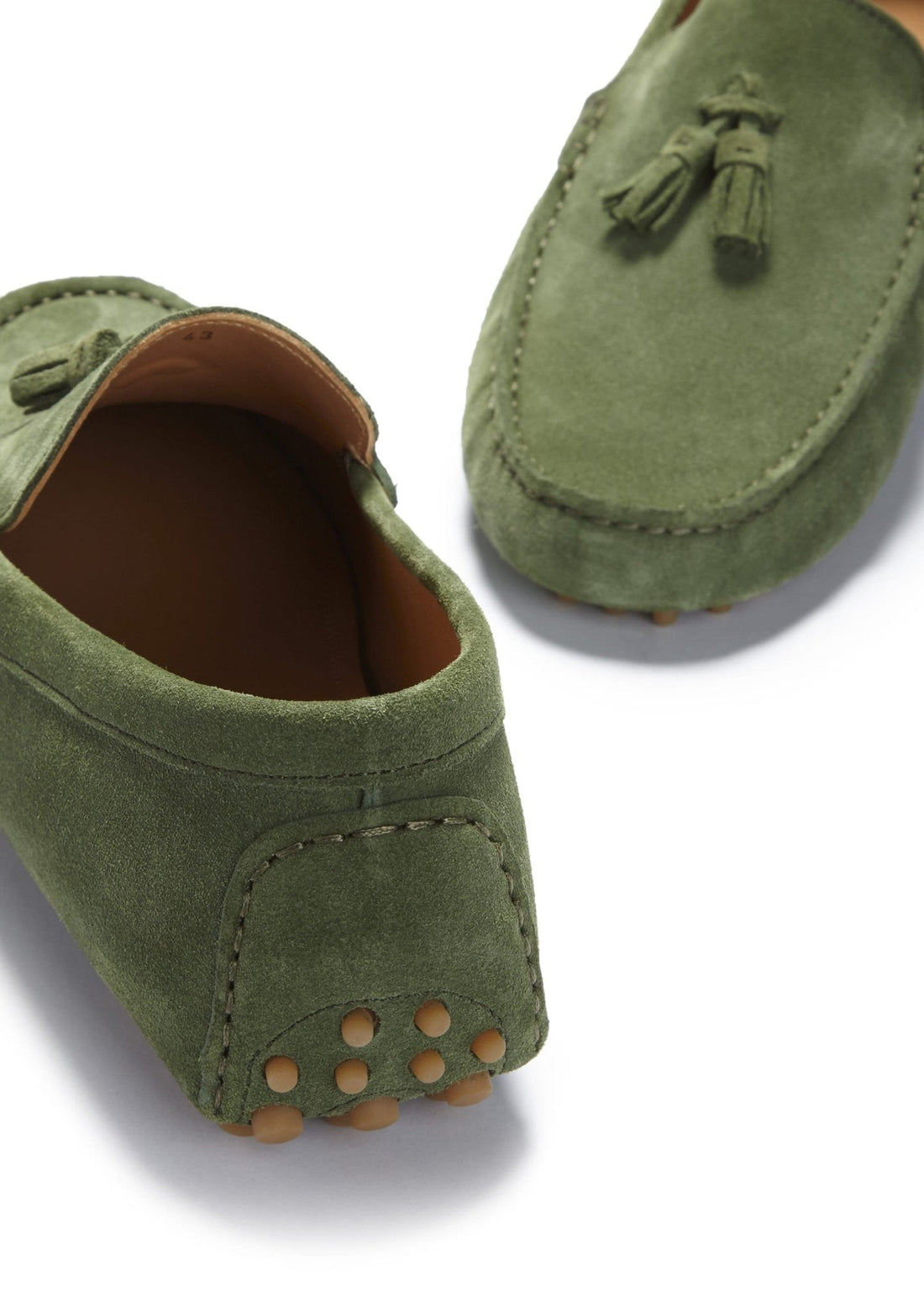 Green suede loafer heel with tan grip studs and brown lining