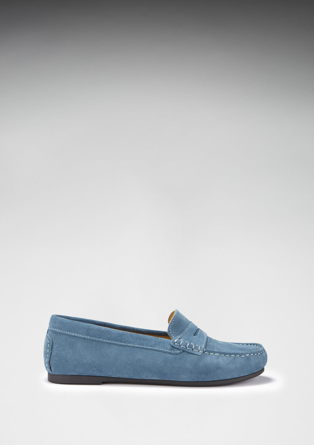Side view of a teal suede penny loafer with a low-profile sole