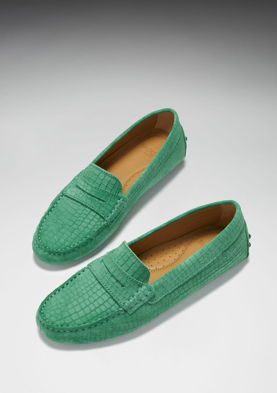 Pair of emerald embossed suede penny loafers with tan insoles