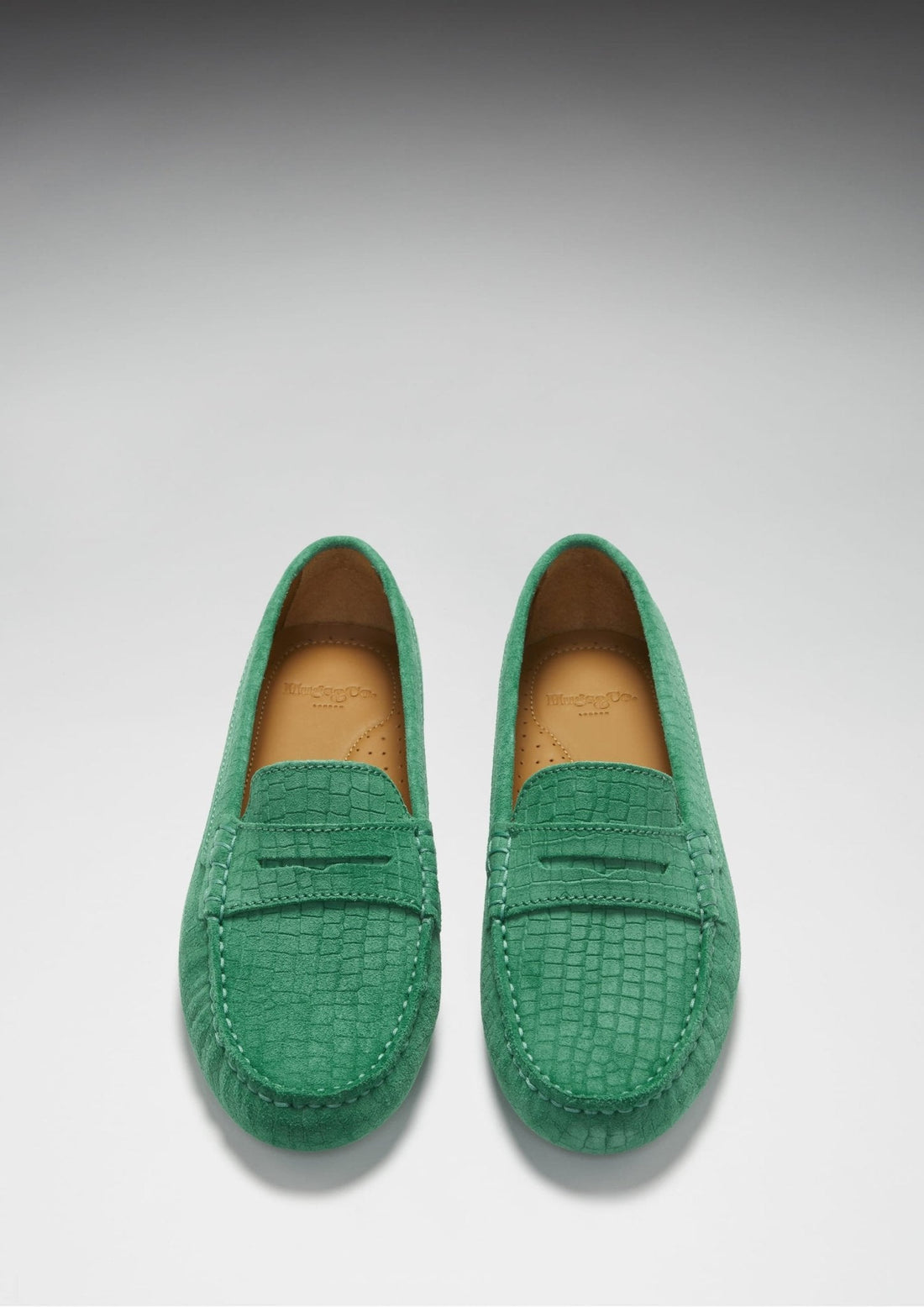 Pair of emerald embossed suede penny loafers, viewed from above