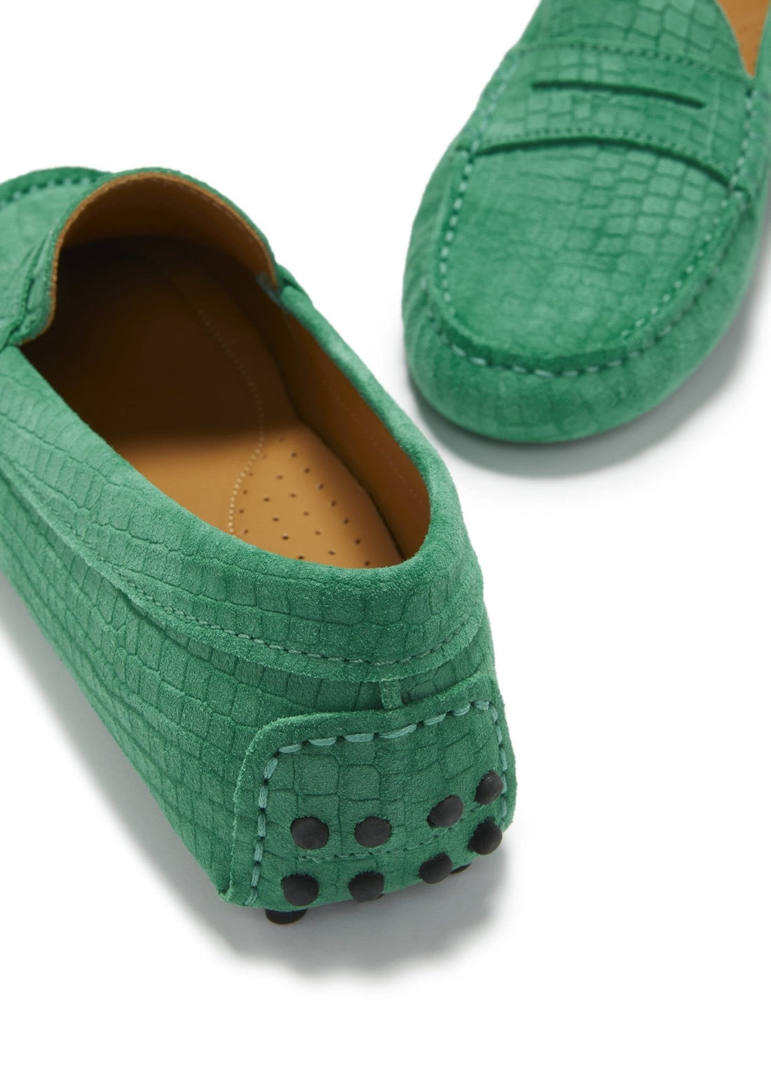 Close-up of embossed suede loafer heel with rubber grip studs