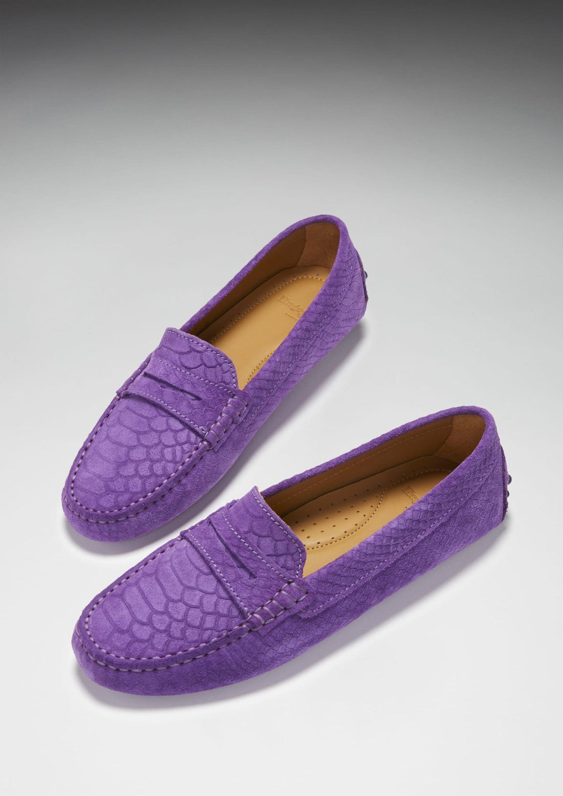 Pair of purple embossed suede penny loafers with tan insoles