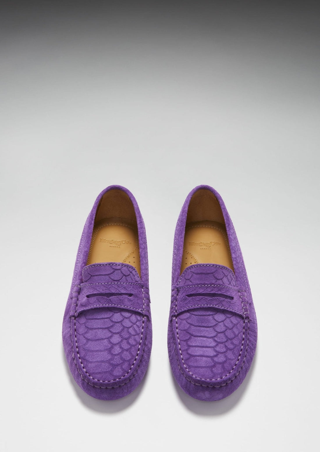 Pair of purple embossed suede penny loafers, viewed from above