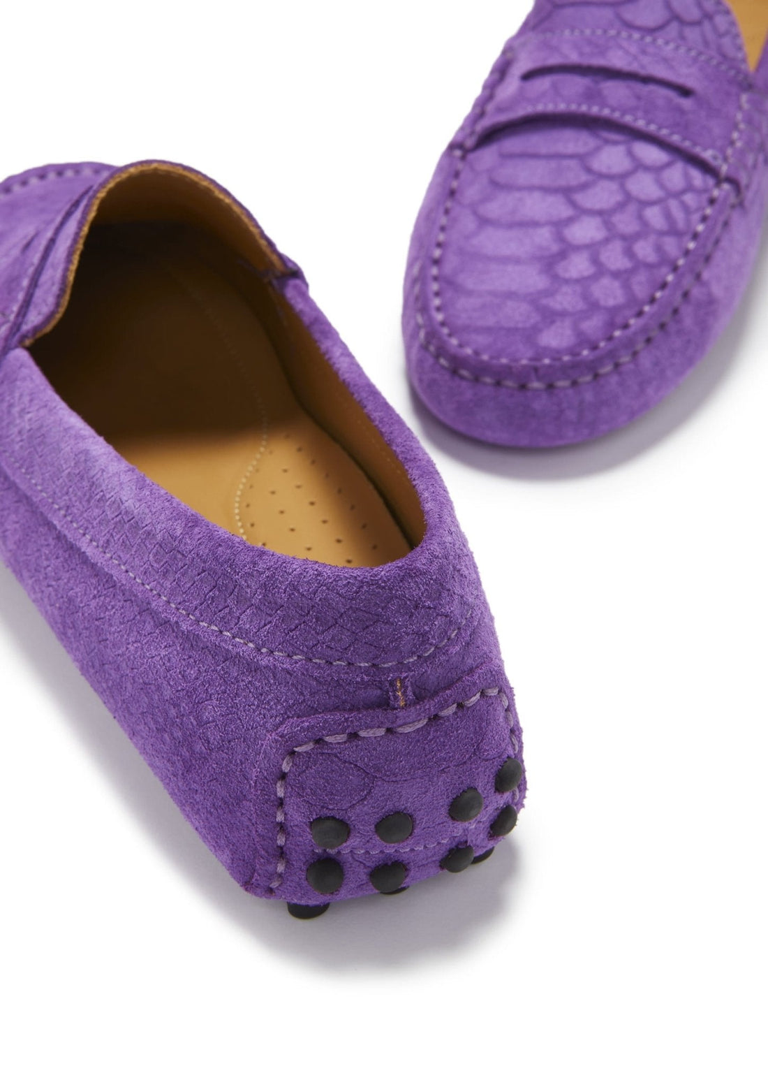 Close-up of purple suede loafer heel with black rubber grip studs