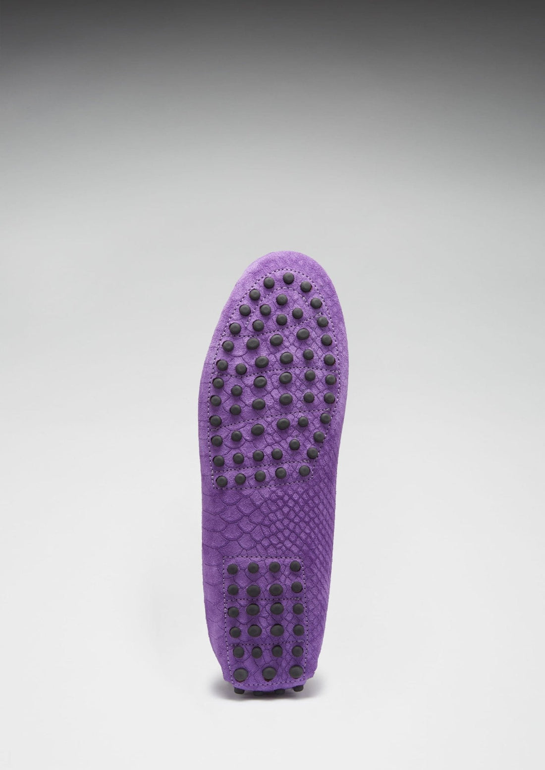 Purple loafer outsole with rows of black rubber grip studs