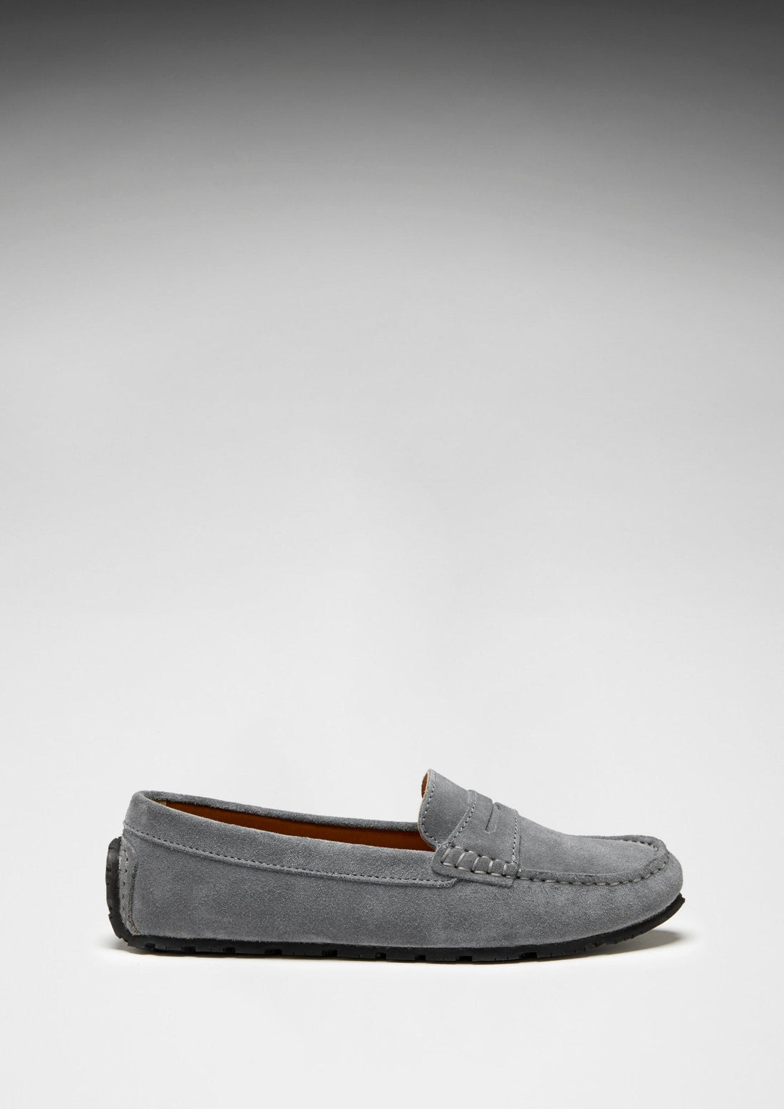 Slate grey suede penny loafer in side profile with black sole