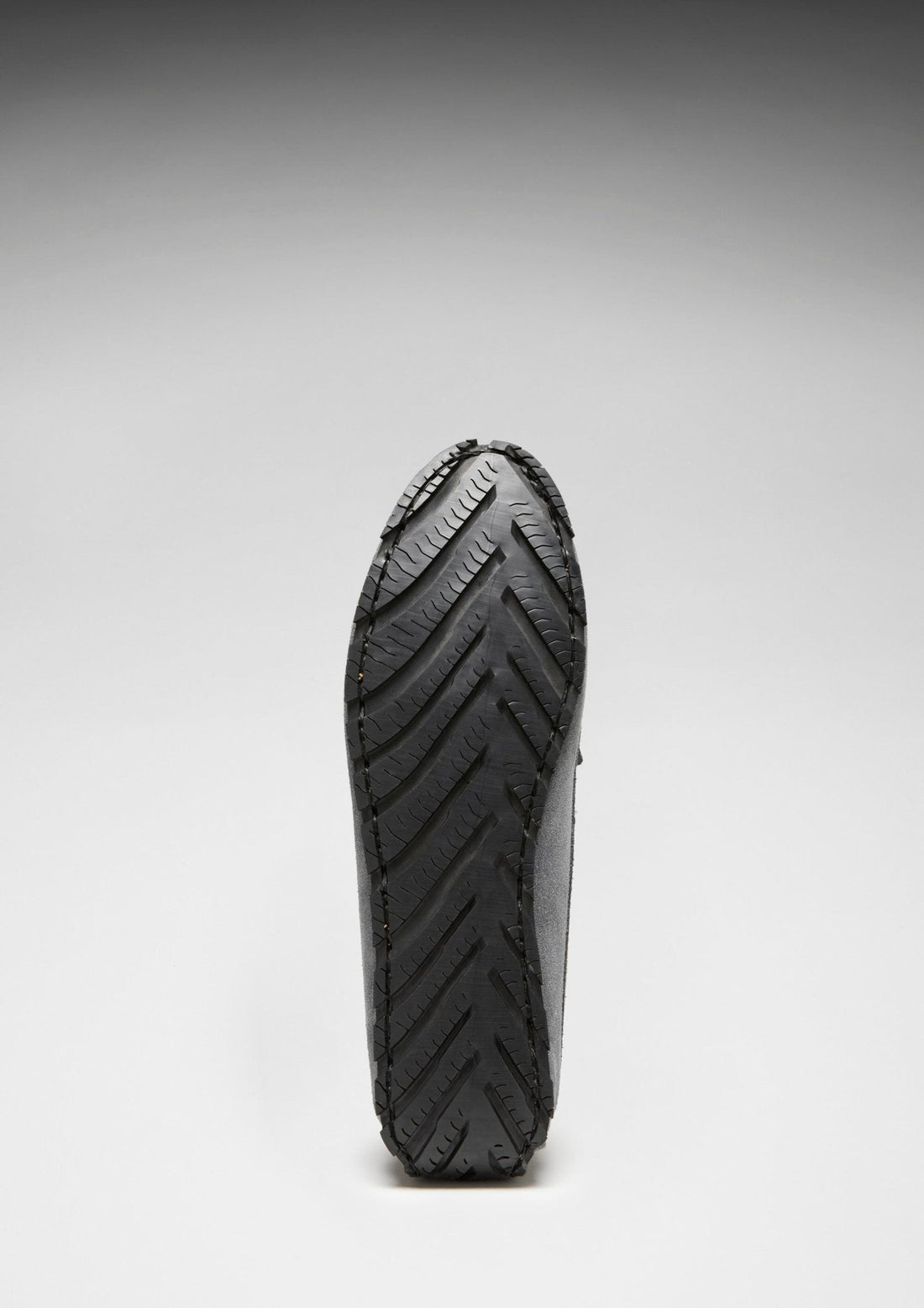 Penny loafer with black rubber outsole and chevron tread