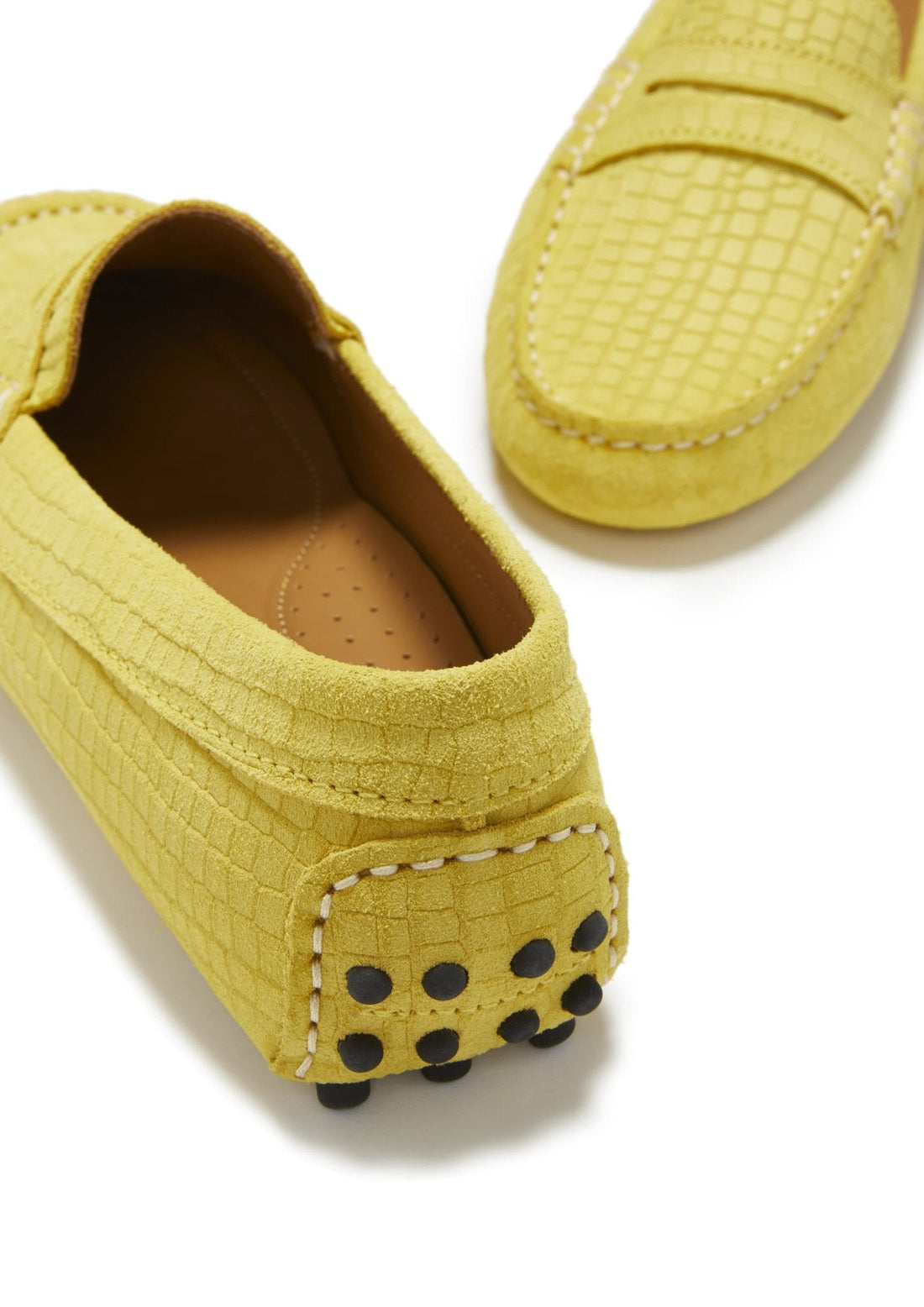 Yellow suede loafer heel with black rubber grip dots and white stitching
