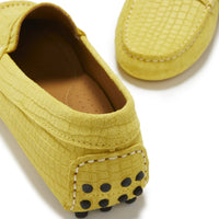 Yellow suede loafer heel with black rubber grip dots and white stitching