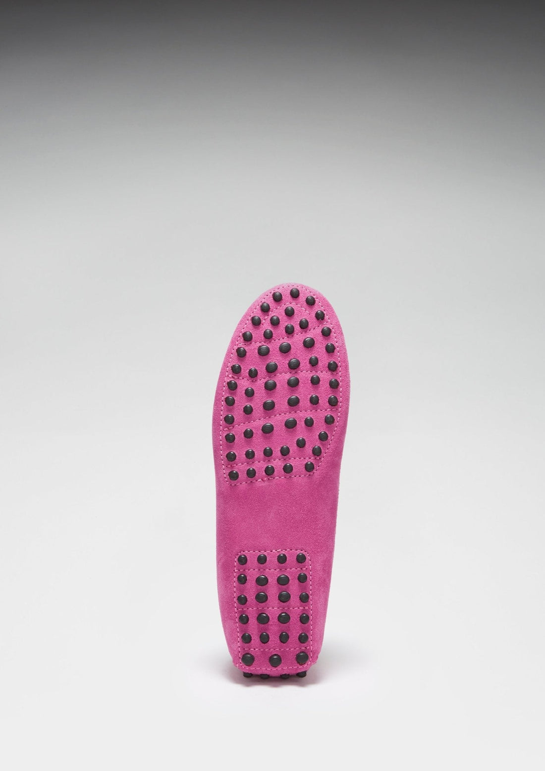 Pink loafer outsole with rows of black rubber driving grips.