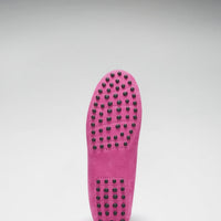 Pink loafer outsole with rows of black rubber driving grips.