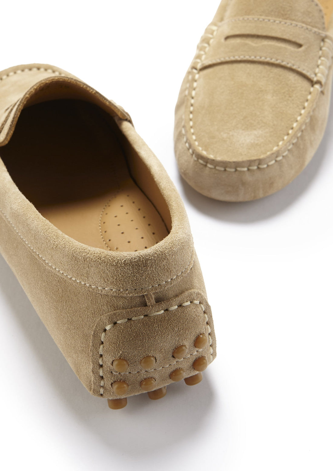 Taupe suede driving loafer heel with rubber grip studs and a perforated insole
