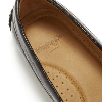 Loafer close-up showing Hugs & Co. logo and perforated tan leather insole