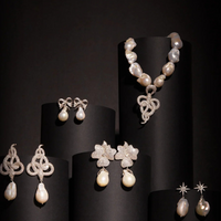 Pearl drop earrings with bow ribbon details on display, assorted styles